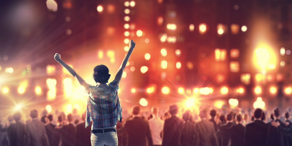 Back view of girl standing in stage lights